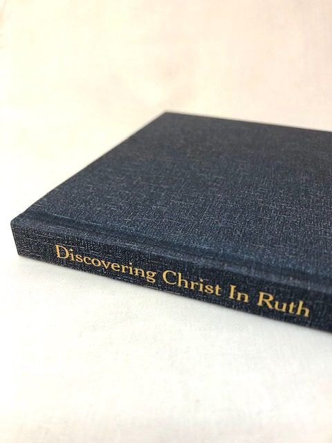 A slim blue hardback book on a white background